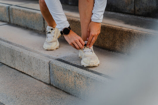 Sportswoman ties her shoelaces