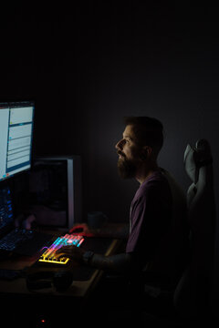 Bearded man working at night