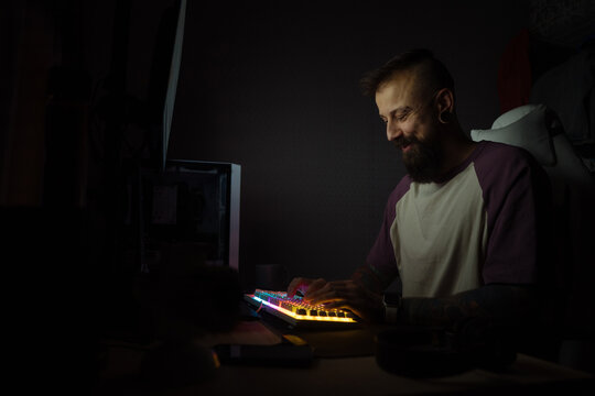 Happy man coding alone at night