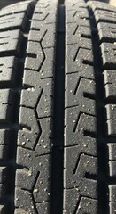 Fototapeta premium Close up view showcases the tread pattern detail on a vehicle's worn rubber exterior