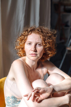 portrait of a young red-haired woman in lingerie
