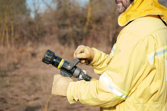 Crop of fireman with a hose