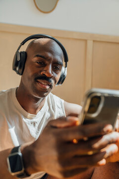 Man Smiling with Headphones and phone