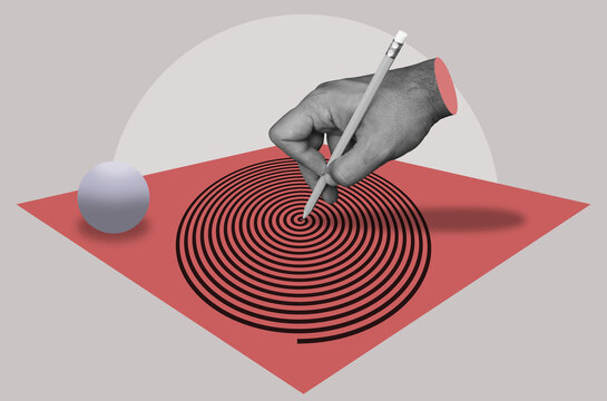 A man's hand draws a spiral with a pencil