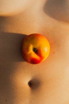 A peach next to the navel