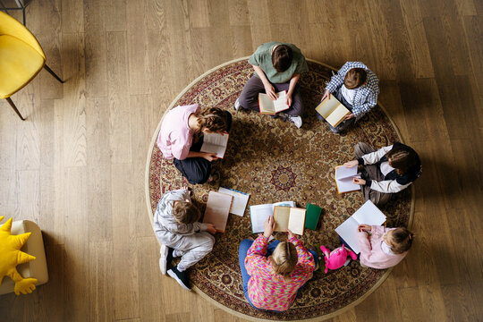 Teacher reads with a group of children