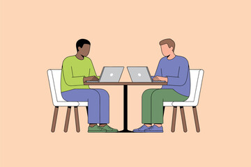 Two men sitting at a table with laptops in a collaborative workspace