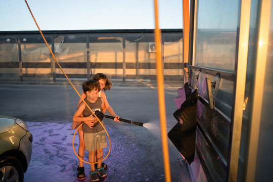 Kids enjoying car washing