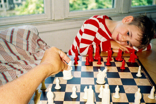 POV child and parent play chess together