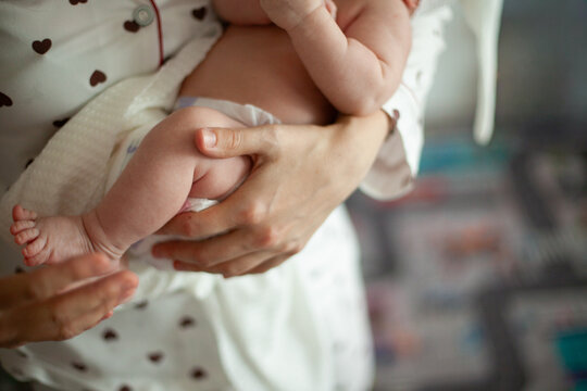 Mother Holding Newborn at Home
