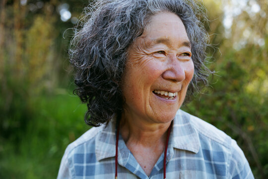 Smiling older woman outdoors in a casual and natural setting