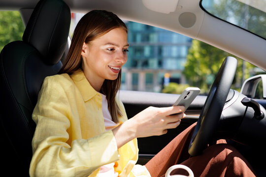 Portrait Woman Smiling at Phone Inside Modern Car