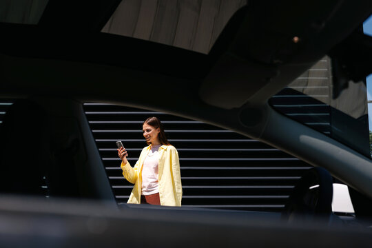 Woman with Phone Outside Through Car Window