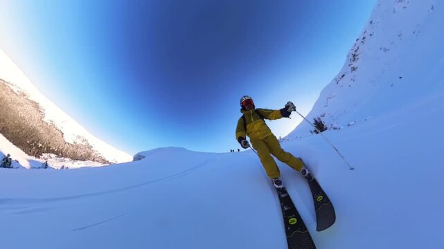 Adrenaline-Fueled Heliskiing: Freeride Skier Carving Through Fresh Powder Snow on a Mountain Tour