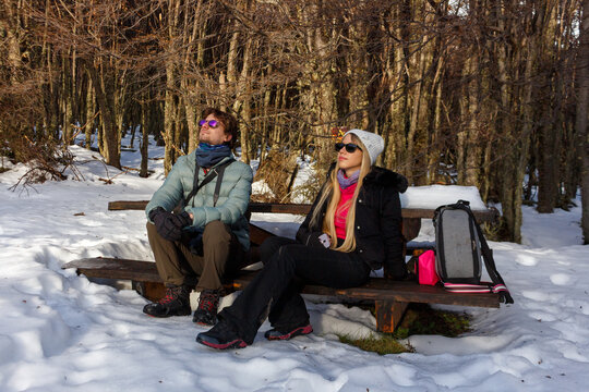 Couple Enjoying a Winter Break in a Snowy Forest