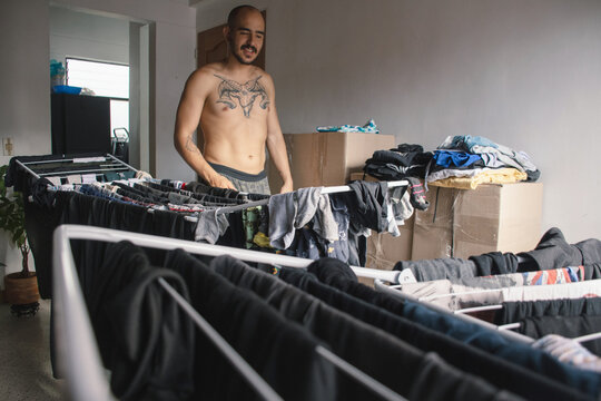 Man folding laundry in a cozy indoor setting during the day