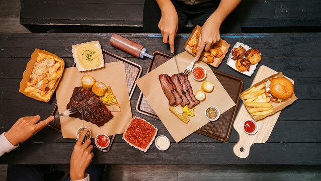 Delicious BBQ Feast With a Burger, Fries and Desserts at a restaurant