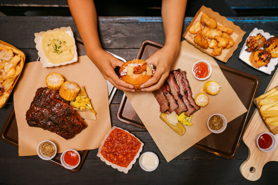 Delicious BBQ Feast With a Burger, Fries and Desserts at a restaurant