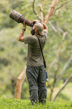 Wildlife photographer in full action in the jungle