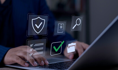Businessman typing on laptop with virtual document approval and security checklist icons. Concept of secure data verification, compliance, and digital workflow automation.