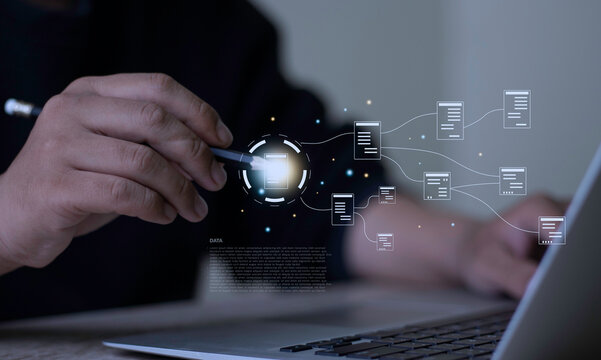 Businessman holding pencil pointing at virtual document workflow flowchart on laptop. Concept of Enterprise Resource Planning (ERP), data structure, and business process automation.