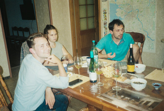 Friends Enjoy an Evening Together With Drinks and Snacks