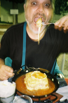 Man Eating  Sandwich at Outdoor Restaurant
