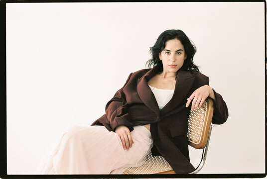 Model Relaxing in Stylish Outfit Indoors