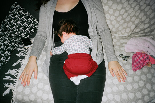 Baby cuddling with mom on pattern blanket