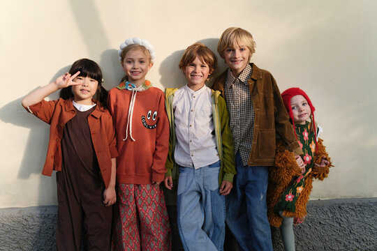 Group of children dressed in colorful costumes posing outdoors