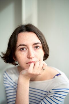 Contemplative Moment Captured in a Soft Sunlit Room