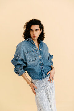 Queer model posing  on beige background