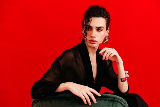 Queer man wearing elegant jewelry and sheer fashion