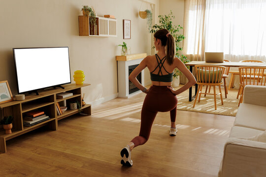 Woman doing lunges exercising at home