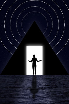 Silhouette of a man standing in the doorway of a pyramid