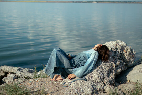 woman in blue dress by the water