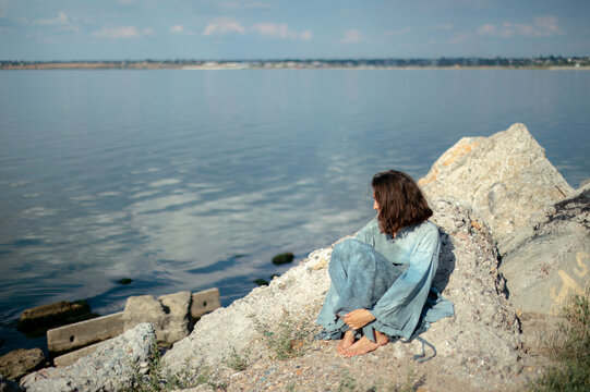 woman in blue dress by the water