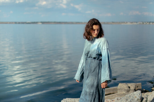 woman in blue dress by the water