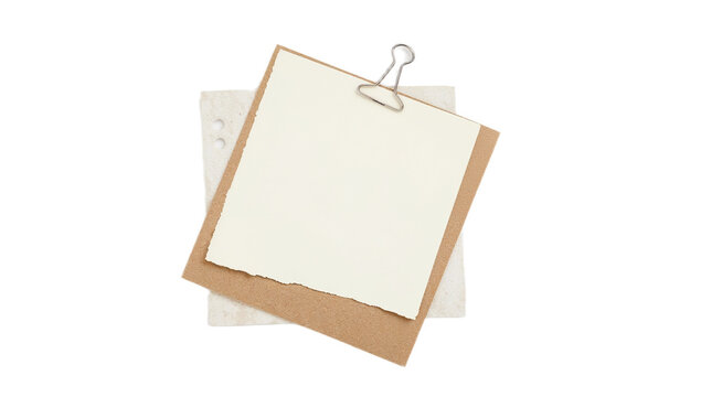Minimalist composition featuring a layered stack of paper scraps held together by a binder clip on a clean white background