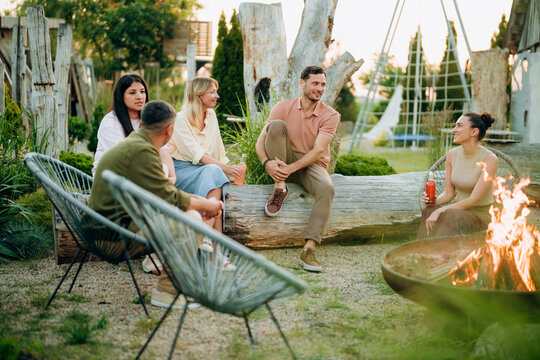 Friends are talking around a campfire