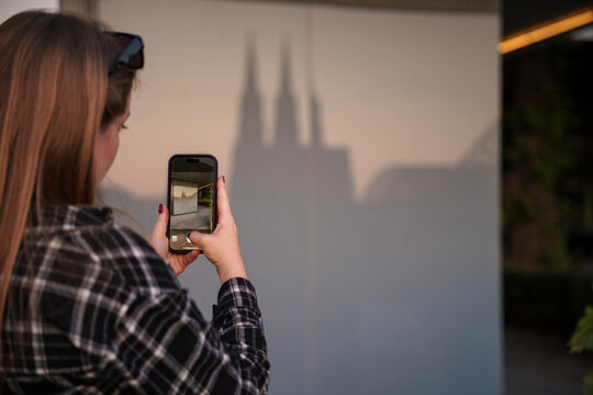 Traveller taking a photo of Cathedral Reflection