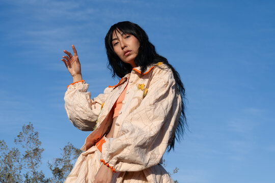 Fashion woman posing in oversized beige clothing