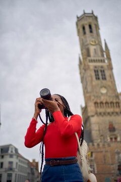 Capturing Moments Near a Historic Clock Tower in the City Square