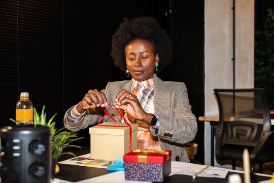 Woman packing gift at office 