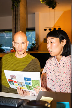 Two Professionals Collaborate on a Project in a Stylish Office Space