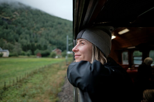 Women Observing Scenic View From Train Window on a Foggy Day