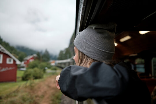 Women Observing Scenic View From Train Window on a Foggy Day