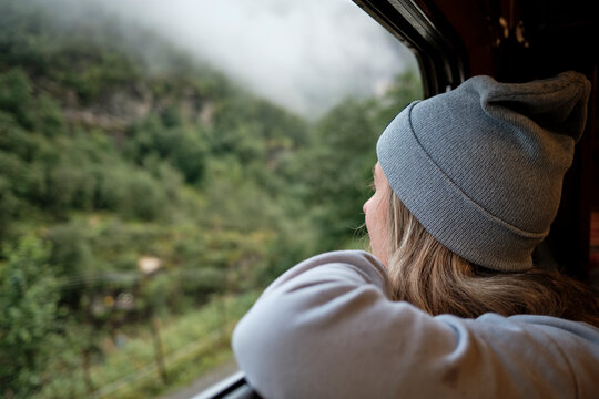 Women Observing Scenic View From Train Window on a Foggy Day
