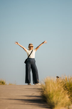 Joyful Woman with Arms Raised