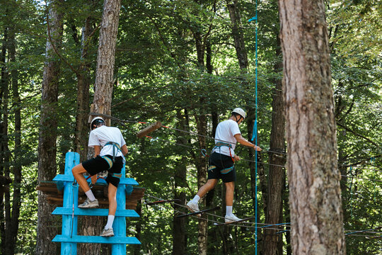 Two Young Men on Rope Course